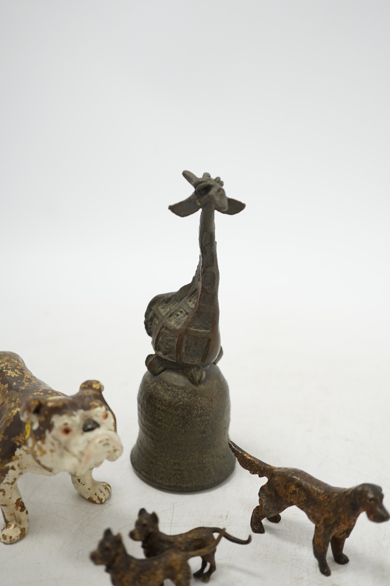 Three cold painted bronze dogs and a bronze giraffe handled bell, bell 13.5cm high. Condition - fair